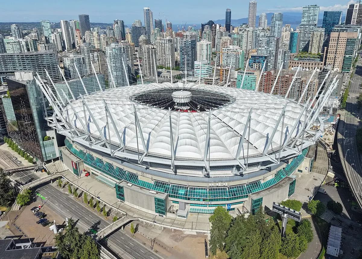 BC Place stadium in downtown Vancouver with the North Shore mountains behind the city.